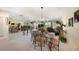 Dining room featuring glass table and metal chairs, open to living area at 124 W Cypress Ct, Oldsmar, FL 34677