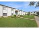 Condo building exterior showcasing landscaping and walkway at 124 W Cypress Ct, Oldsmar, FL 34677