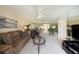 Living room featuring brown leather furniture and a large mirror at 124 W Cypress Ct, Oldsmar, FL 34677