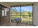 Relaxing screened balcony overlooking lush green landscape at 124 W Cypress Ct, Oldsmar, FL 34677