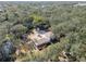 Aerial view showing house, yard, and surrounding trees at 13833 Vacation Ln, Odessa, FL 33556