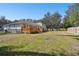 Large backyard with grassy area and wooden fence at 13833 Vacation Ln, Odessa, FL 33556