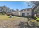 Large backyard with grassy area and detached garage at 13833 Vacation Ln, Odessa, FL 33556