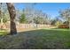 Large backyard with grassy area and wooden fence at 13833 Vacation Ln, Odessa, FL 33556