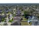 An aerial view of a home in a well-developed residential area with a large number of trees at 1525 Banner Elk St, Valrico, FL 33594