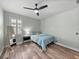 Bedroom featuring a full bed, wood floors and a ceiling fan at 1525 Banner Elk St, Valrico, FL 33594