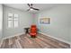 Cozy bedroom with hardwood floors, natural light, and comfortable seating area at 1525 Banner Elk St, Valrico, FL 33594