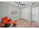 Bright bedroom featuring an orange recliner and a ceiling fan at 1525 Banner Elk St, Valrico, FL 33594