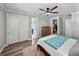 Bright bedroom featuring wood floors, walk-in closet, and a ceiling fan at 1525 Banner Elk St, Valrico, FL 33594