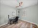 Bedroom with a desk, chair, and storage, illuminated by a ceiling fan at 1525 Banner Elk St, Valrico, FL 33594