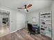 Bright room with wood floors, desk, fan and shelving unit at 1525 Banner Elk St, Valrico, FL 33594