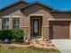 Close up of the front door with beautiful landscaping, a stone walkway and ADT security system at 1525 Banner Elk St, Valrico, FL 33594