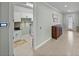 Hallway featuring tile floors and access to the laundry room and front door at 1525 Banner Elk St, Valrico, FL 33594