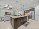 Spacious kitchen island with granite counters, stainless steel appliances, and modern pendant lighting at 1525 Banner Elk St, Valrico, FL 33594