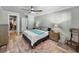 Main bedroom featuring wood floors, ceiling fan and walk in closet at 1525 Banner Elk St, Valrico, FL 33594