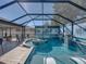 This stunning screened-in pool features a spa, water fountain, and comfortable seating area at 1525 Banner Elk St, Valrico, FL 33594