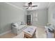 Sitting area featuring a comfortable sofa, display cabinet, and shuttered window at 1525 Banner Elk St, Valrico, FL 33594