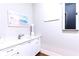 White vanity with sink and beach-themed art at 1818 4Th E St, Palmetto, FL 34221