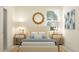 Bedroom with a queen bed, nightstands, and a large sunburst mirror at 18426 Serene Lake Loop, Lutz, FL 33548