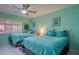 Guest bedroom with two twin beds and ceiling fan at 19029 Us Highway 19 N # 32B, Clearwater, FL 33764