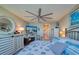 Main bedroom with coastal bedding and a ceiling fan at 19029 Us Highway 19 N # 32B, Clearwater, FL 33764