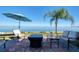 Relaxing patio overlooking the water with seating and umbrella at 19029 Us Highway 19 N # 32B, Clearwater, FL 33764