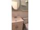 Bathroom with vanity, toilet, and oval mirror at 2020 N World Parkway Blvd # 12, Clearwater, FL 33755