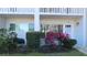 View of condo building unit entrance with patio furniture at 2020 N World Parkway Blvd # 12, Clearwater, FL 33755