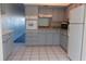 Renovated kitchen featuring granite counters and gray cabinets at 2020 N World Parkway Blvd # 12, Clearwater, FL 33755