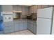 Efficient kitchen with light gray cabinets and granite countertops at 2020 N World Parkway Blvd # 12, Clearwater, FL 33755