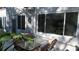 Private patio with table, chairs, and tropical plants at 2020 N World Parkway Blvd # 12, Clearwater, FL 33755