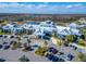 Aerial view of community clubhouse, pool, tennis courts, and surrounding landscape at 20292 Sea Glass Cir, Land O Lakes, FL 34638