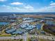 Aerial view of community with lake, pool, and tennis courts at 20292 Sea Glass Cir, Land O Lakes, FL 34638