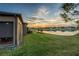 Screened patio overlooking a lake at sunset at 20292 Sea Glass Cir, Land O Lakes, FL 34638