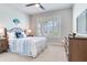 Cozy bedroom with a queen-size bed, dresser, and window shutters at 20292 Sea Glass Cir, Land O Lakes, FL 34638