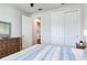 Well-lit bedroom with double doors leading to a hallway and spacious closet at 20292 Sea Glass Cir, Land O Lakes, FL 34638