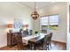 Bright dining room with a wooden table and chairs, overlooking a scenic view at 20292 Sea Glass Cir, Land O Lakes, FL 34638