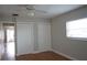 Well-lit bedroom featuring two closets and wood floors at 2202 Clubhouse Dr # 173, Sun City Center, FL 33573