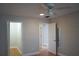 Bright bedroom with ceiling fan, wood floors, and ample closet space at 2202 Clubhouse Dr # 173, Sun City Center, FL 33573