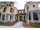 Grand two-story home with stone accents and palm trees at 2254 Chianti Pl # 68, Palm Harbor, FL 34683