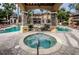 Community hot tub with pergola and lounge chairs nearby at 2254 Chianti Pl # 68, Palm Harbor, FL 34683