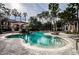 Resort-style pool with waterfall feature and lounge chairs at 2254 Chianti Pl # 68, Palm Harbor, FL 34683