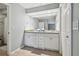 Bathroom with granite countertops, white cabinets, and a large mirror at 2519 Crowder Ln, Tampa, FL 33629