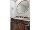 Modern bathroom with oval mirror and ornate wood vanity at 2519 Crowder Ln, Tampa, FL 33629