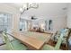 View of dining area with a long wooden table and a view into the living room at 2519 Crowder Ln, Tampa, FL 33629