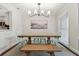 Dining room with a farmhouse table, light green chairs, and a modern chandelier at 2519 Crowder Ln, Tampa, FL 33629