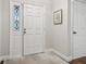 Bright entryway with white door, wood floors, and stained glass window at 2519 Crowder Ln, Tampa, FL 33629