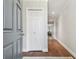 Light and airy entryway with gray door and hardwood floors at 2519 Crowder Ln, Tampa, FL 33629