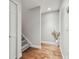 Hallway with wood floors, white door, and staircase at 2519 Crowder Ln, Tampa, FL 33629