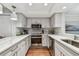 Modern kitchen with white cabinets, quartz countertops, and stainless steel appliances at 2519 Crowder Ln, Tampa, FL 33629